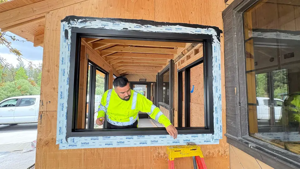 JD Glass installer setting a window frame